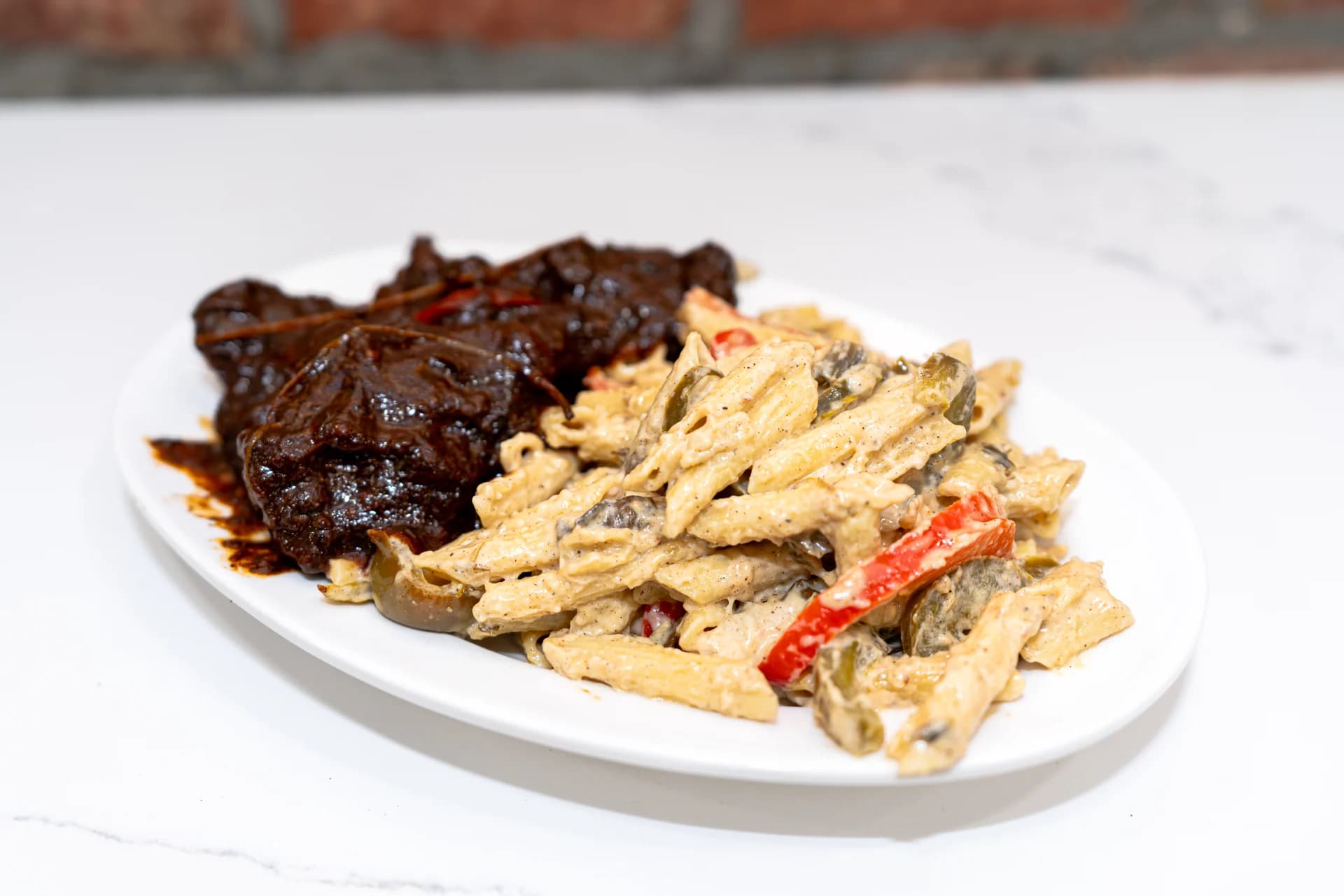 Oxtails and creamy Rasta pasta with peppers